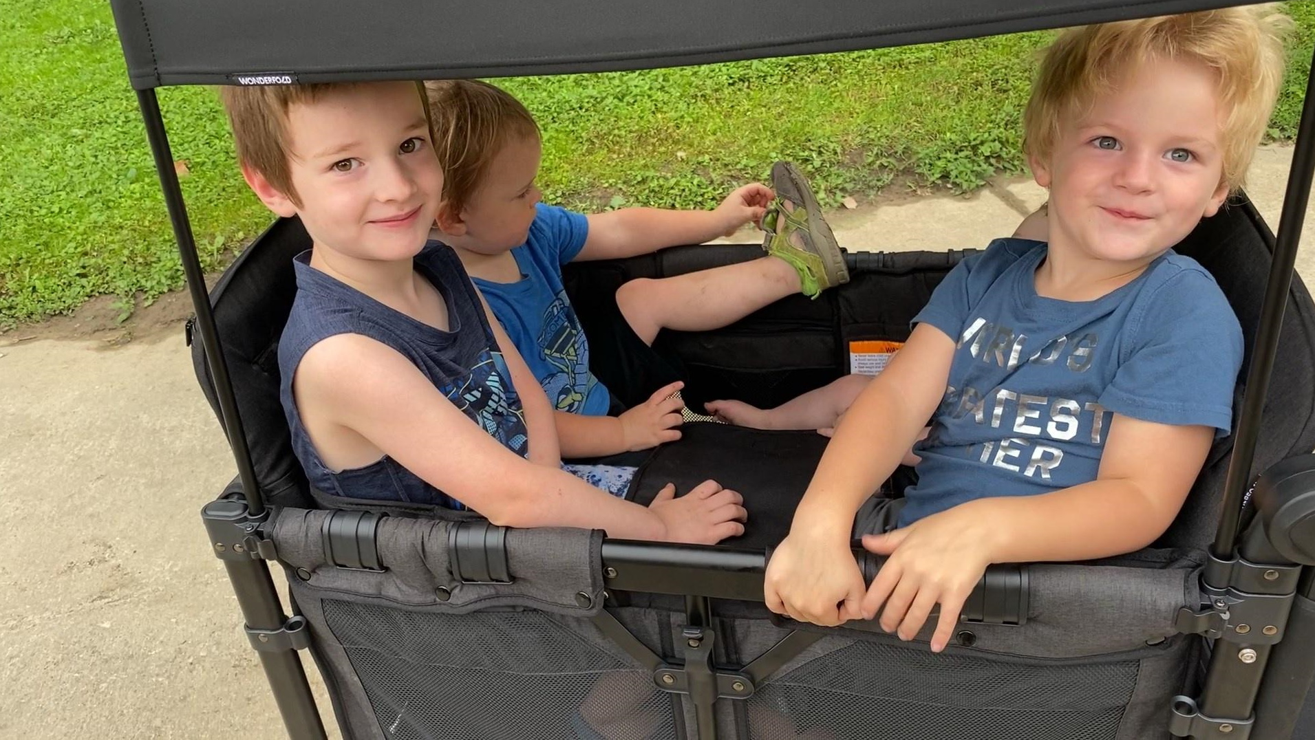 four little boys in the wonderfold w4 elite stroller wagon