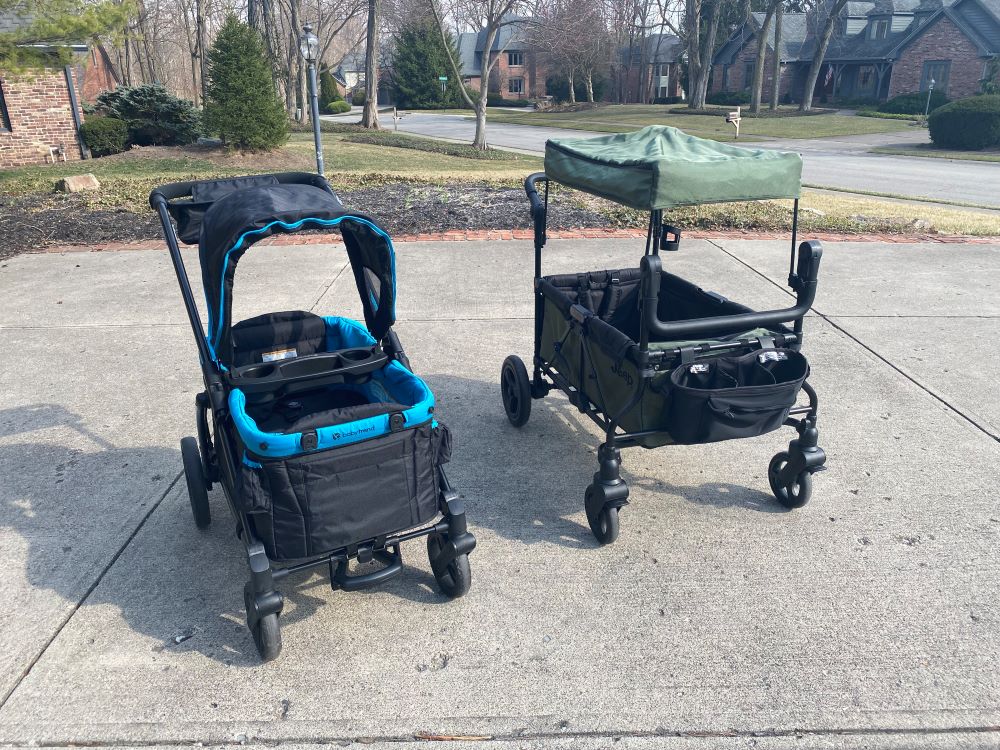 The baby trend expedition and jeep wrangler stroller wagons sitting outside side by side