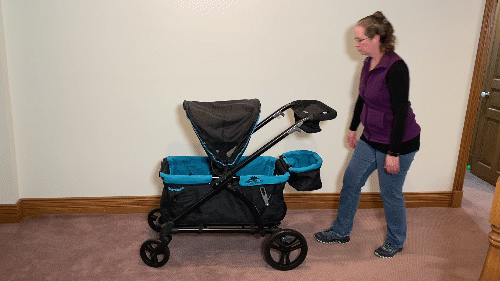 a mom folding the baby trend 2-in-1 expedition stroller wagon