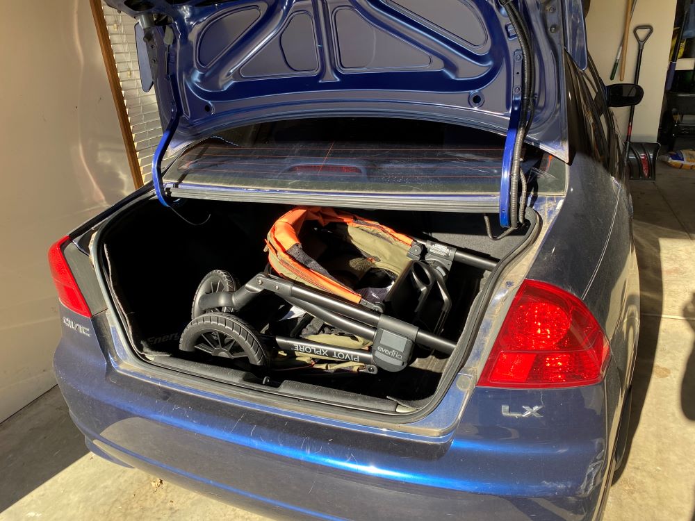 Evenflo Pivot Xplore in the trunk of a small sedan