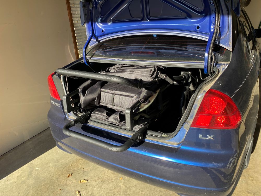 Jeep wrangler sticking out of the trunk of a honda civic. It doesn't fit