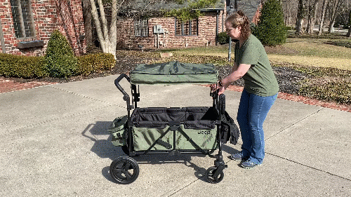 a mom removing the canopy and folding the jeep wrangler stroller wagon