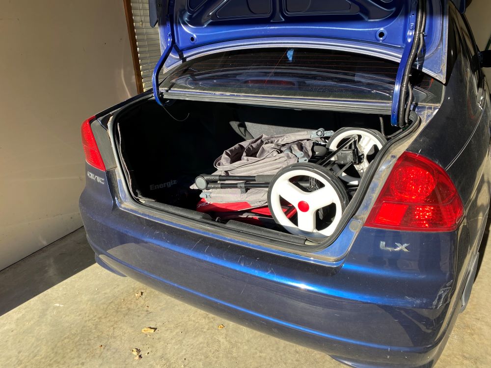 The Radio Flyer Discovery Stroll 'N Wagon snugly in the trunk of a Honda Civic.