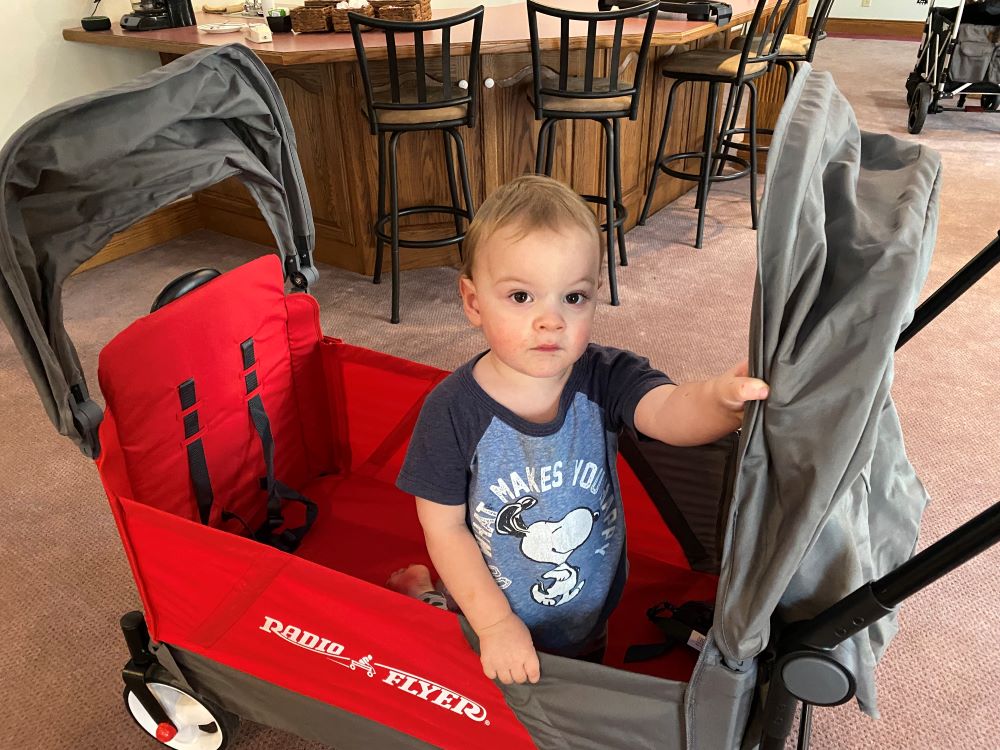 Radio Flyer Discovery Stroll 'N Wagon with toddler sitting in the middle