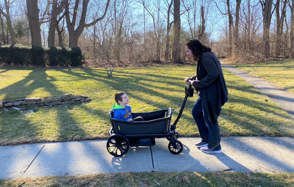 The Veer Cruiser stroller wagon on a walk with mom and child