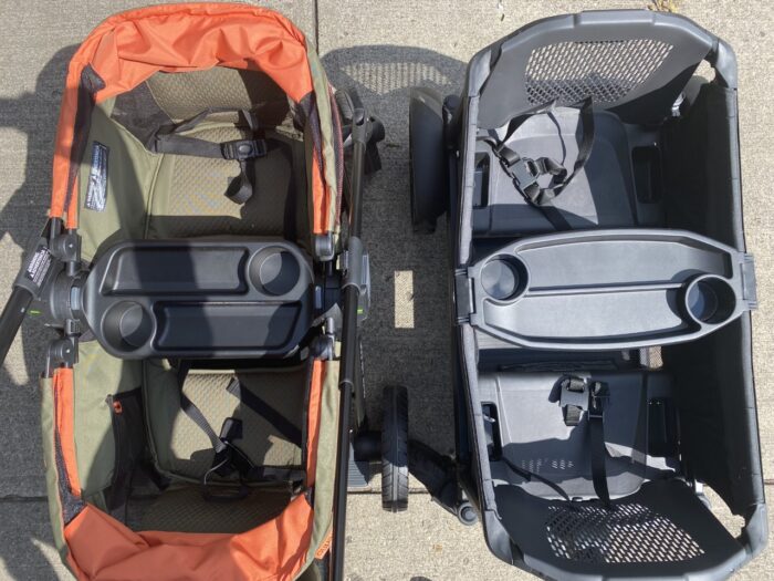 The insides of the evenflo pivot xplore and the veer cruiser from a top view with the wagons side by side.