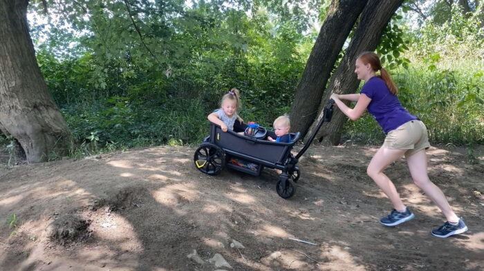 veer cruiser pushed on trail up a steep hill with mom and 2 kids