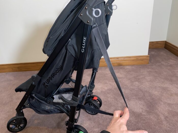 uppababy g-luxe carry strap goes over your shoulder and is attached to the frame