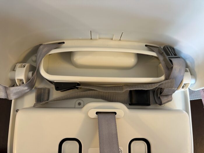 The OXO Tot Booster adjustable straps lie underneath the seat cushion