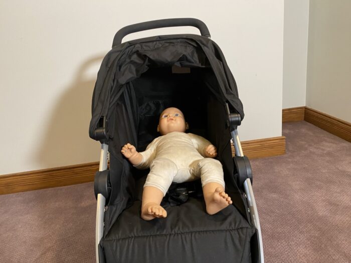 B-lively with seat back fully reclined. Doll laying in stroller