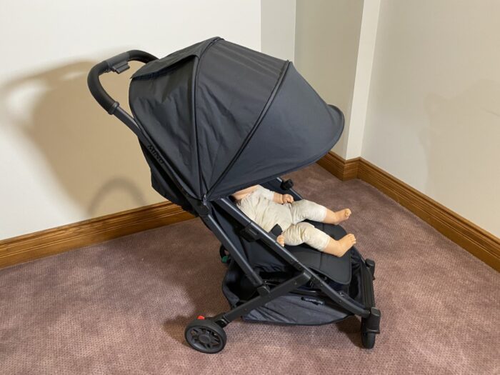 uppababy minu v2 canopy extending over the knees of a doll