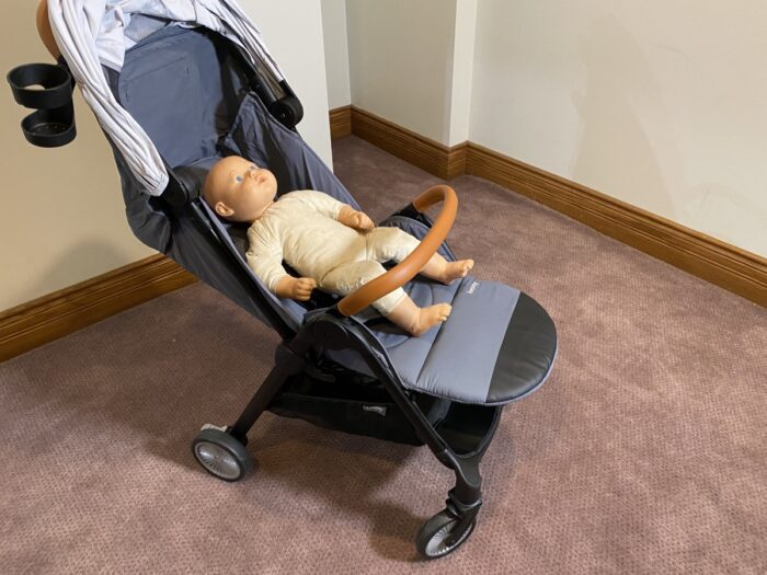 besrey with seat fully reclined and leg rest up. doll laying in stroller