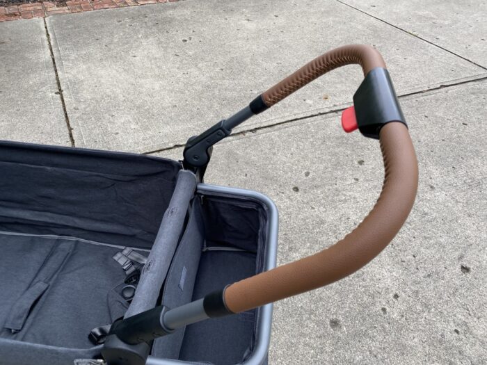 showing leather push handle of the ever advance side-unzip stroller wagon