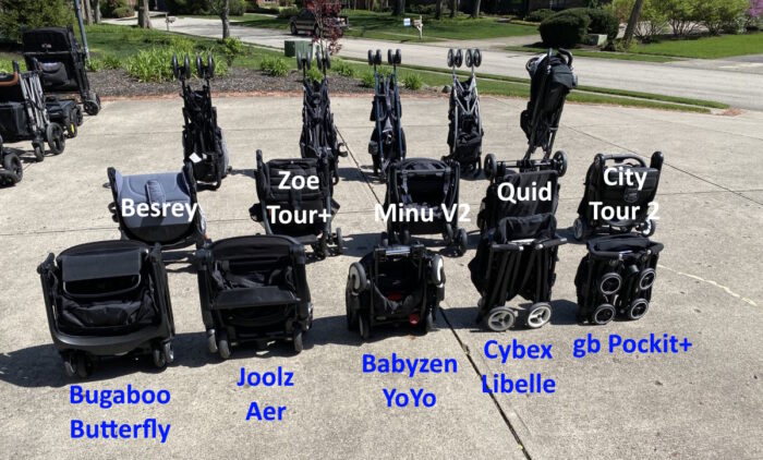 16 strollers folded and standing on driveway