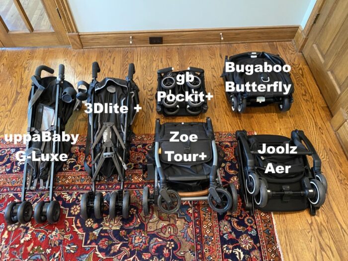uppababy g-lux, summer infant 3dlite+, gb pockit+, bugaboo butterfly, zoe tour+ and joolz aer strollers all folded and laying on the floor with labels identifying them.