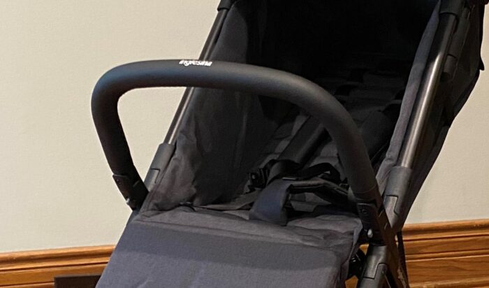 bumper bar on the inglesina quid showing release buttons where the bar attaches to the frame