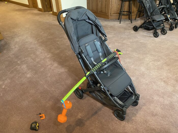 stroller with weight hanging over side for tip over testing