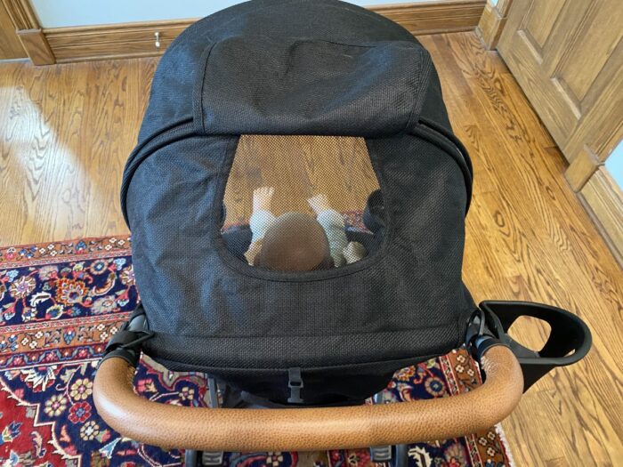 zoe tour showing doll in seat of stroller visible through the peekaboo window in the canopy