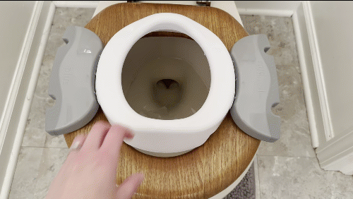 GIF of Kalencom potty seat sliding around a lot on an adult toilet