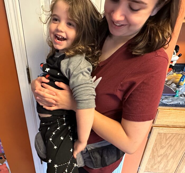 holding 40 lb child with tushbaby on the front