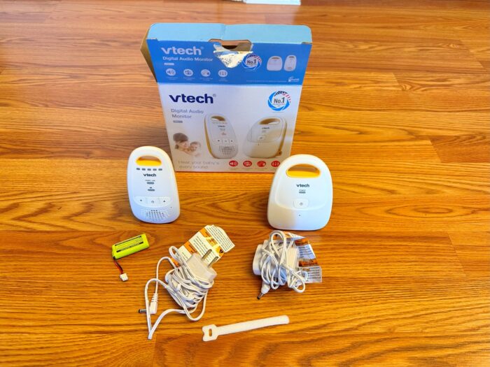 The vtech dm111 audio monitor and receiver and parts on the floor with box in the background